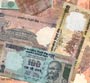 Rupee hits a 20-month low of 64.25 a dollar as FIIs take down markets in tax fight